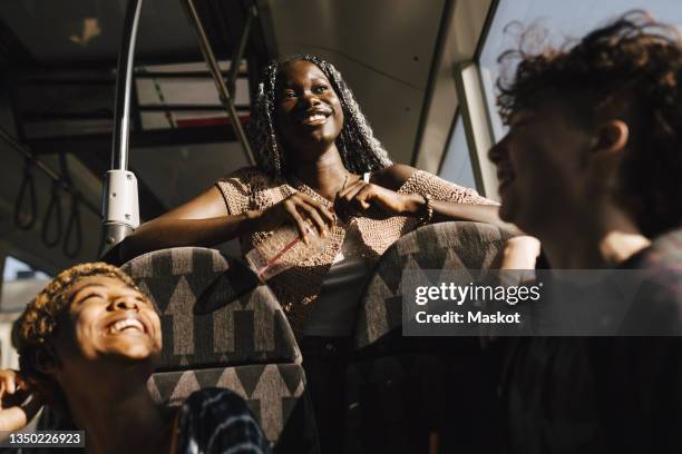 happy multiracial lgbtqia friends in bus on sunny day - young gay boys fotos stockfoto's en -beelden