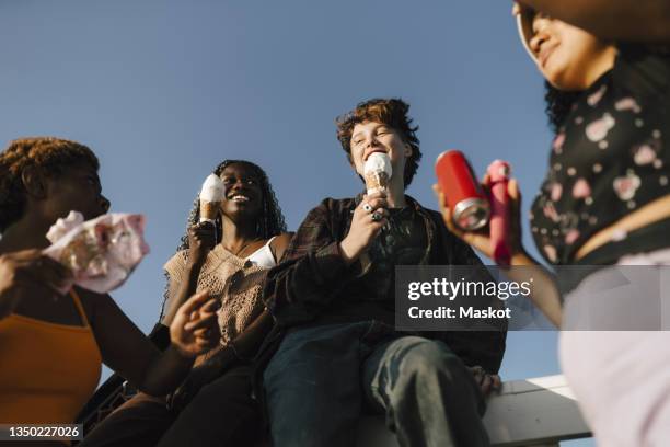 smiling multiracial friends with ice creams on sunny day - boy and girl eating ice cream stock-fotos und bilder
