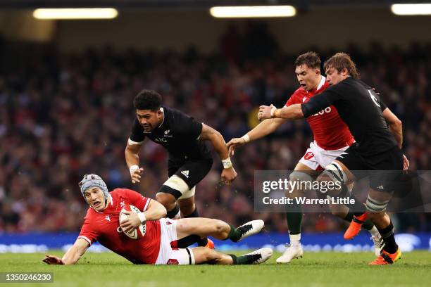 Jonathan Davies of Wales is tackled during the Autumn International match between Wales and New Zealand at Principality Stadium on October 30, 2021...