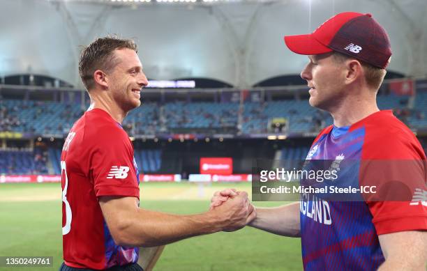 Jos Buttler and Eoin Morgan of England celebrate following the ICC Men's T20 World Cup match between Australia and England at Dubai International...