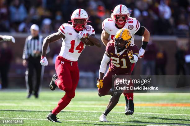 Rahmir Johnson of the Nebraska Cornhuskers runs with the ball past Justus Harris of the Minnesota Golden Gophers in the third quarter of the game at...