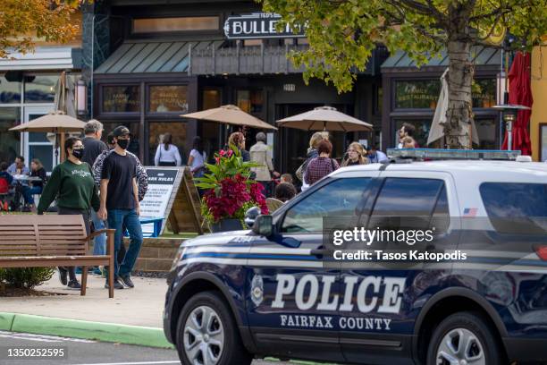 Police car is parked outside as people visit Mosaic Shopping Center Mall on October 30, 2021 in Fairfax Virginia. Law enforcement in Northern...