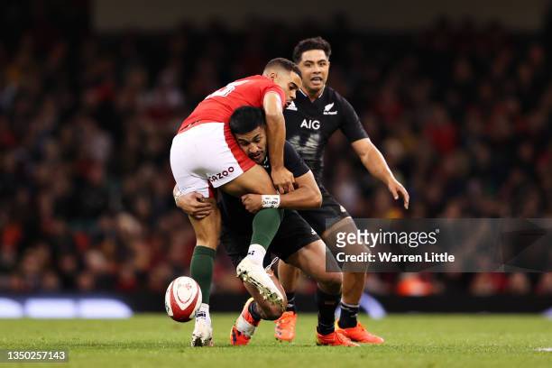 Ben Thomas of Wales is tackled by Rieko Ioane of New Zealand during the Autumn International match between Wales and New Zealand at Principality...