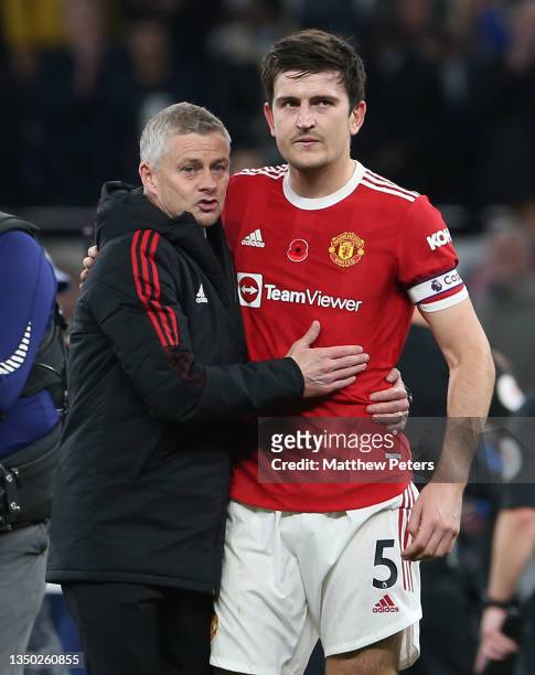 Manager Ole Gunnar Solskjaer of Manchester United walks off with Harry Maguire after the Premier League match between Tottenham Hotspur and...