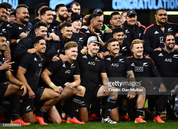 Beauden Barrett of New Zealand celebrates with team mates after receiving his 100th cap during the Autumn International match between Wales and New...