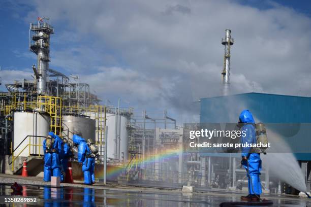 emergency firefighters at the scene of chemical accident with leakage of dangerous acid . - protective suit stock pictures, royalty-free photos & images