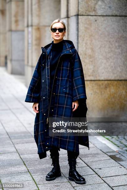 Influencer Marlies-Pia Pfeifhofer, wearing a dark blue checked raincoat by Woolrich, a dark blue turtleneck by Woolrich, black jeans by Mother Denim,...