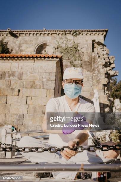 Man carries out maintenance work on a grave in the cemetery of Santa Mariña de Dozo, on 22 October, 2021 in Cambados, Pontevedra, Galicia, Spain....