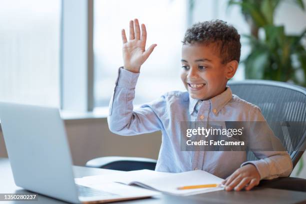 boy raising his hand during virtual learning - one boy only stock pictures, royalty-free photos & images