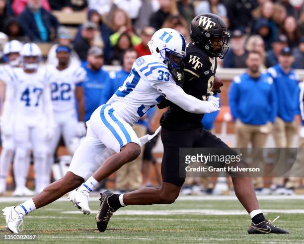 Perry of the Wake Forest Demon Deacons makes a catch againt Leonard Johnson of the Duke Blue Devils during the first half of their game at Truist...