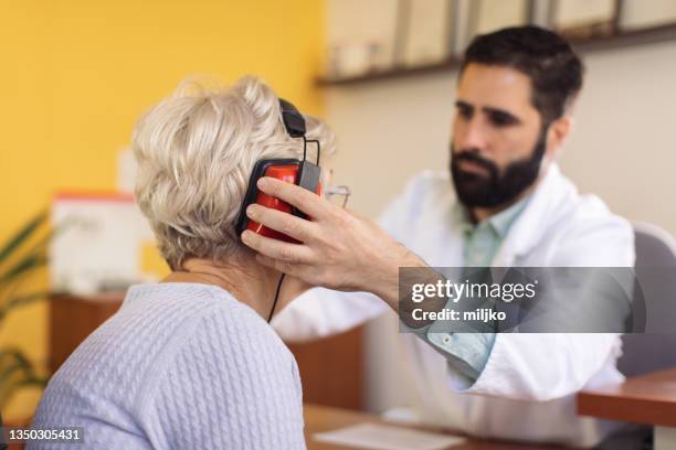 hearing test and buying hearing aid - ear exam stock pictures, royalty-free photos & images