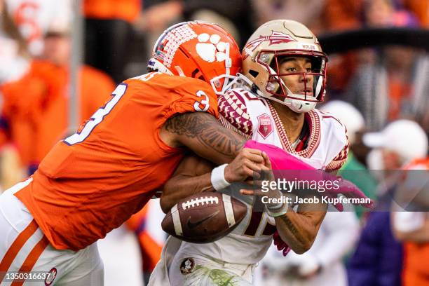 Defensive end Xavier Thomas of the Clemson Tigers forces a fumble from quarterback Jordan Travis of the Florida State Seminoles during the third...