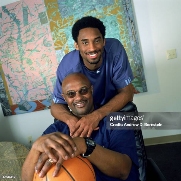 Guard Kobe Bryant of the Los Angeles Lakers poses for a portrait with his father, former NBA player Joe "Jellybean" Bryant, after purchasing a 50...