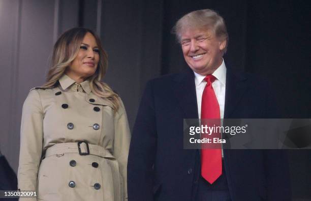 Former first lady and president of the United States Melania and Donald Trump look on prior to Game Four of the World Series between the Houston...