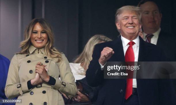 Former first lady and president of the United States Melania and Donald Trump look on prior to Game Four of the World Series between the Houston...