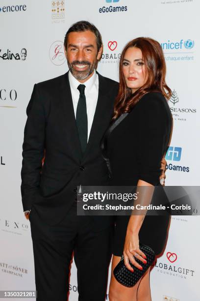 Robert Pires and Jessica Lemarie Pires attend the photocall during the Global Gift Gala 2021 at Four Seasons Hotel George V on October 30, 2021 in...