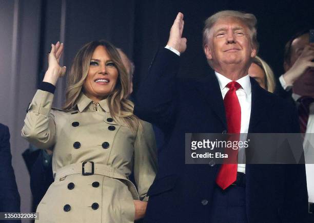 Former first lady and president of the United States Melania and Donald Trump do "the chop" prior to Game Four of the World Series between the...