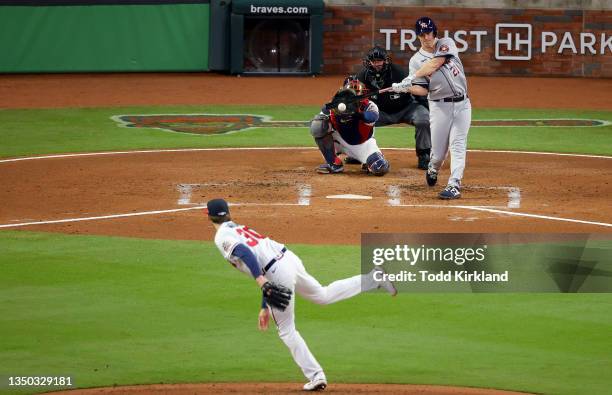 Zack Greinke of the Houston Astros hits a single against Kyle Wright of the Atlanta Braves during the second inning in Game Four of the World Series...