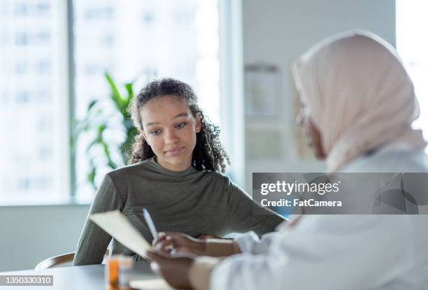 patient discussing medication - teen and doctor stock pictures, royalty-free photos & images