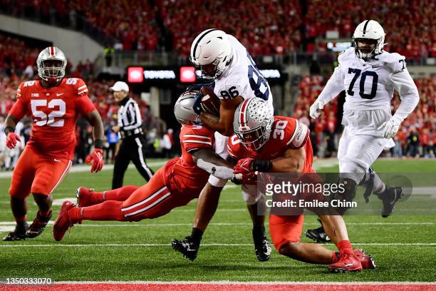 Brenton Strange of the Penn State Nittany Lions carries the ball into the end zone against the Ohio State Buckeyes for a touchdown during the first...