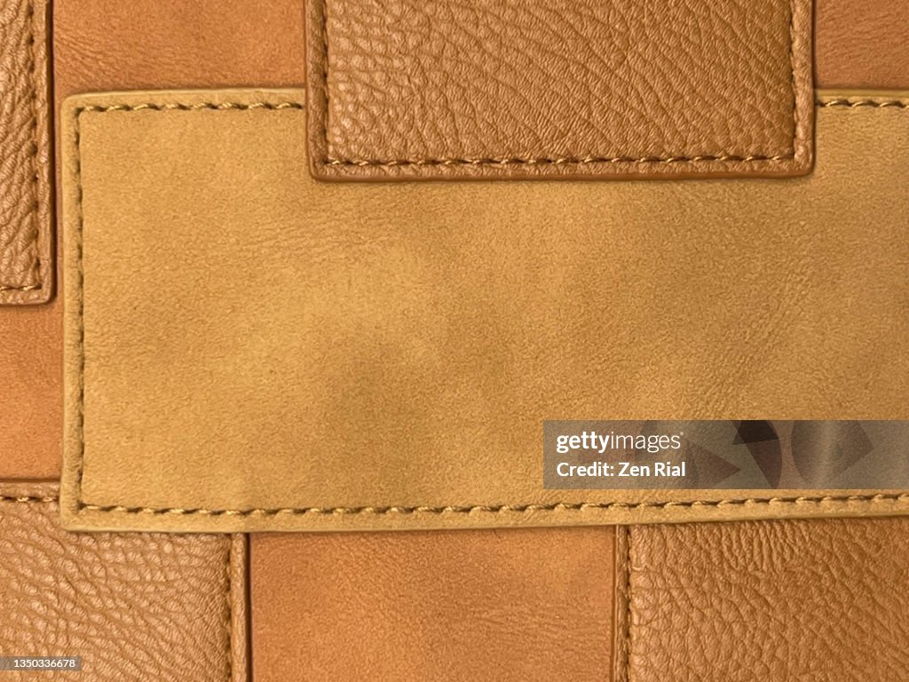 Decorative detail on handbag in various shades of brown