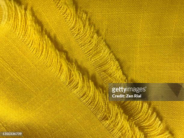 fringes on folded yellow scarf - fringing ストックフォトと画像