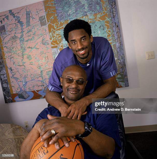 Guard Kobe Bryant of the Los Angeles Lakers poses for a portrait with his father, former NBA player Joe "Jellybean" Bryant, after purchasing a 50...