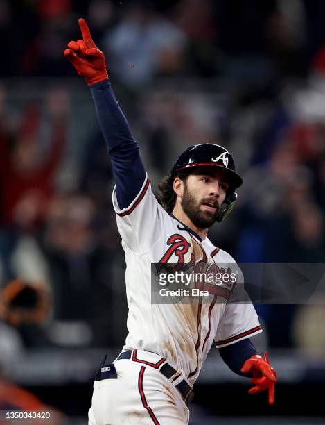 Dansby Swanson of the Atlanta Braves celebrates as he rounds the bases after hitting a solo home run against the Houston Astros during the seventh...