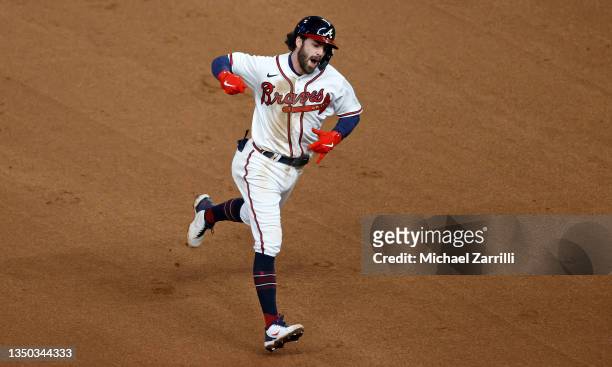 Dansby Swanson of the Atlanta Braves celebrates as he rounds the bases after hitting a solo home run against the Houston Astros during the seventh...
