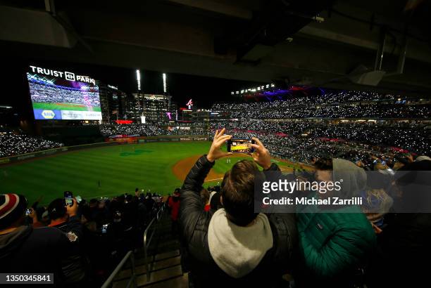Fan takes a photo in Game Four of the World Series between the Houston Astros and the Atlanta Braves at Truist Park on October 30, 2021 in Atlanta,...