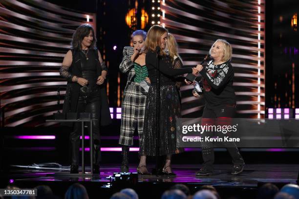 Kathy Valentine, Belinda Carlisle, Charlotte Caffey and Gina Schock of The Go-Go's speak onstage during the 36th Annual Rock & Roll Hall Of Fame...