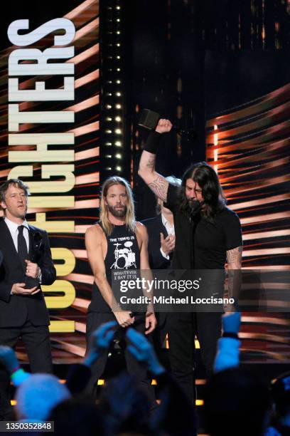 Chris Shiflett, Taylor Hawkins and Dave Grohl of Foo Fighters are inducted onstage during the 36th Annual Rock & Roll Hall Of Fame Induction Ceremony...