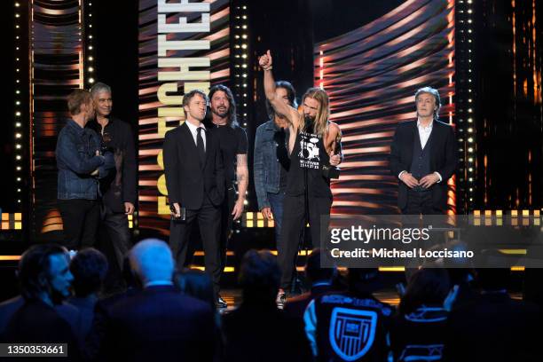 Nate Mendel, Pat Smear, Chris Shiflett, Dave Grohl, Rami Jaffee and Taylor Hawkins and of Foo Fighters are inducted by Paul McCartney onstage during...