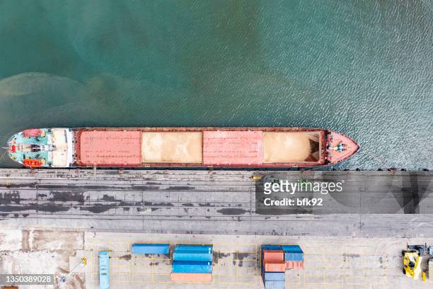 aerial view of a large cargo ship unloading grain. - rice production stockfoto's en -beelden