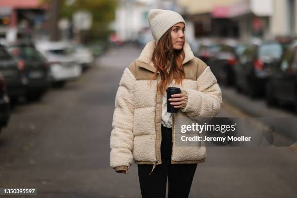 Anja Balovneva wearing The North Face puffer jacket, Weekday black pants on October 25, 2021 in Cologne, Germany.