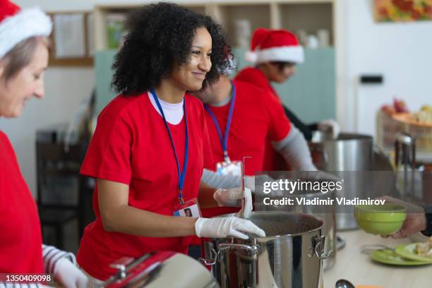 christmas food donations in a soup kitchen - homeless winter stock pictures, royalty-free photos & images