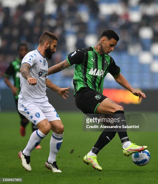 Lorenzo Tonelli of Empoli FC competes for the ball with Gianluca Scamacca of US Sassuolo during the Serie A match between US Sassuolo and Empoli FC...