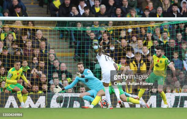 Raphinha of Leeds United scores their side's first goal past Tim Krul of Norwich City during the Premier League match between Norwich City and Leeds...