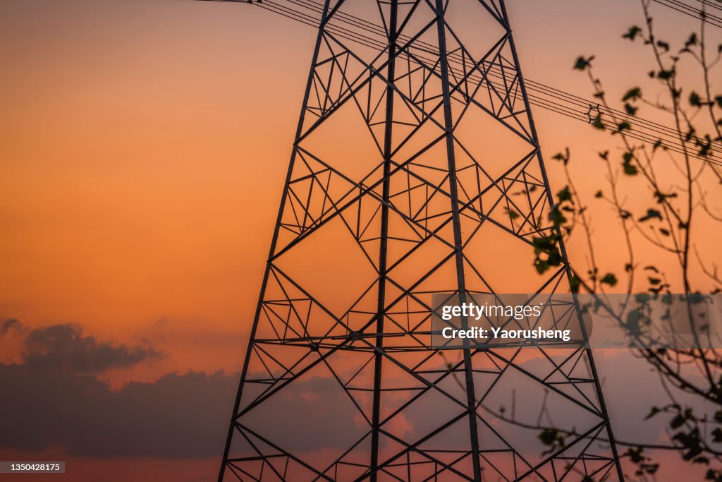 Power lines and pylons at sunset