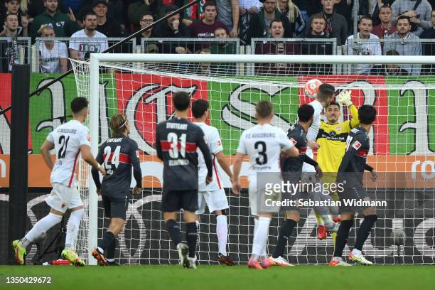 Jeffrey Gouweleeuw of FC Augsburg scores their side's second goal past Fabian Bredlow of VfB Stuttgart during the Bundesliga match between FC...