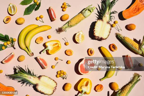 many yellow fruits and vegetables on a yellow background. - detox stockfoto's en -beelden