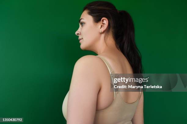 plus size woman near a green wall. - leopard silhouette stock pictures, royalty-free photos & images