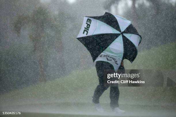 Chase Seiffert of the United States uses an umbrella during heavy rain in the final round of the Butterfield Bermuda Championship at Port Royal Golf...