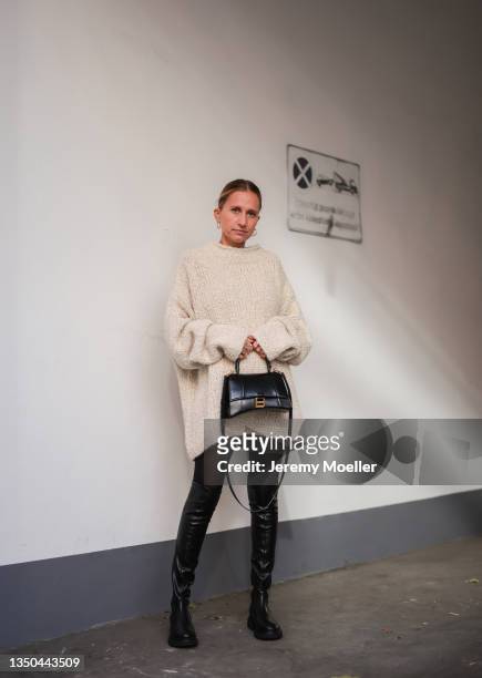 Michi Brandl wearing by Aylin Koenig knit beige sweater, Balenciaga Hourglass black bag, Copenhagen Studios black overknees and black tights on...