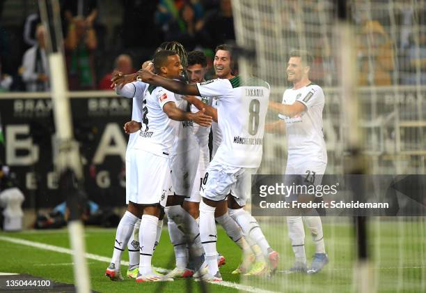 Alassane Plea of Borussia Monchengladbach celebrates with teammates after scoring their side's first goal during the Bundesliga match between...