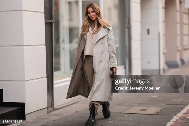 Carmen Kroll wearing Fendi baguette bag, Copenhagen Studios black boots, Oh April trenchcoat, Aeron beige sweater and Nakd brown pants on October 25,...