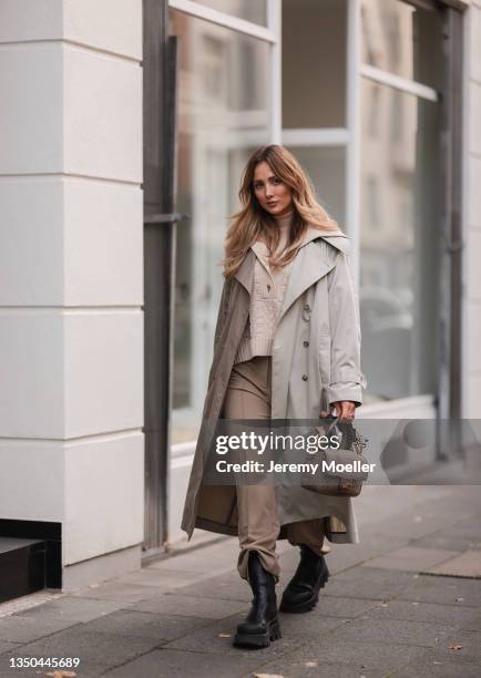 Carmen Kroll wearing Fendi baguette bag, Copenhagen Studios black boots, Oh April trenchcoat, Aeron beige sweater and Nakd brown pants on October 25,...