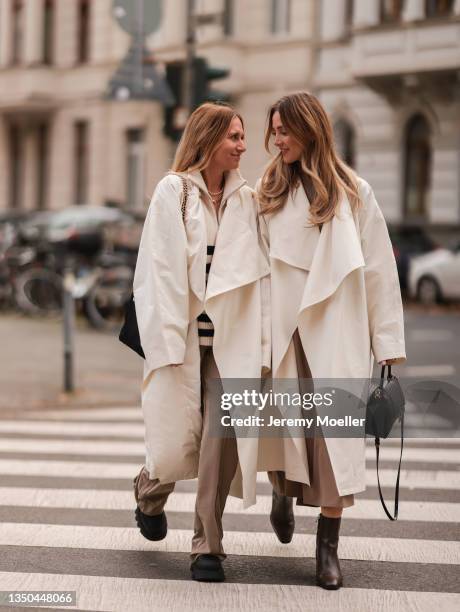 Michi Brandl wearing Copenhagen Studios black boots, Nakd olive pants, Le17Septembre white coat and vintage sweater and Prada black Nylon bag and...