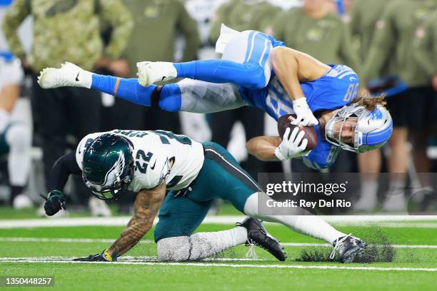Hockenson of the Detroit Lions dives over Marcus Epps of the Philadelphia Eagles during the first quarter at Ford Field on October 31, 2021 in...