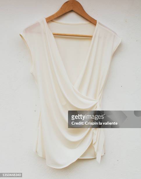 elegant white blouse on a wooden hanger, second hand clothes - hanging blouse stock pictures, royalty-free photos & images